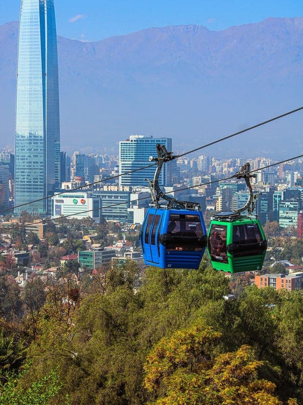 Two Santiago cable car cabins, with the Gran Torre Costanera and the Andes behind